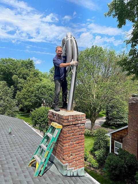 Roger works on a chimney after his mitral valve repair surgery