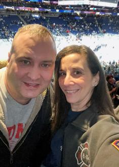 Catherine and her husband at a hockey game just weeks after surgery. 